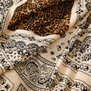 Detailed view of paisley and leopard print pattern on soft linen-feel scarf fabric