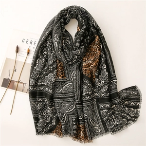 Linen feel scarf featuring paisley and leopard print patchwork with fringe edges