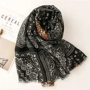 Detail of paisley and leopard print cotton-linen shawl with soft fringed edges