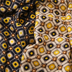 Detail view of the soft cotton-linen fabric with yellow geometric honeycomb print