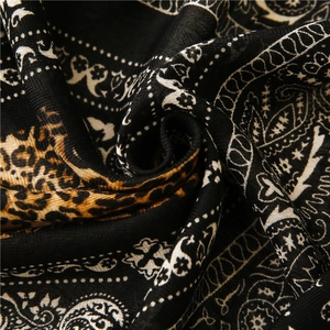 Detail of soft fabric scarf with paisley and leopard print patterns showing soft texture