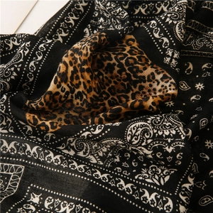 Detailed macro view of the paisley and leopard print pattern on soft linen-feel fabric
