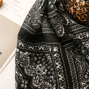 Detail shot of paisley and leopard print scarf fabric texture with herringbone weave