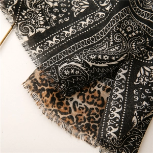 Detail showing paisley and leopard print textures on a cotton-linen blend scarf shawl