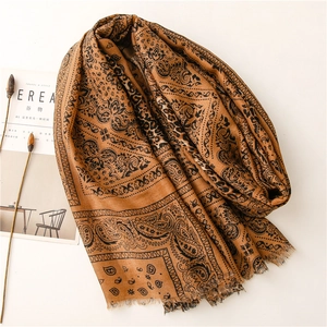 Detail of bohemian paisley pattern on brown shawl with soft frayed edge craftsmanship