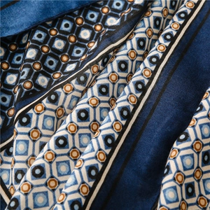 Macro shot of twill texture and geometric patterns on a navy blue linen feel scarf