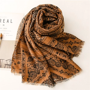 Detail of paisley leopard print cotton linen shawl with frayed edges and retro patterns
