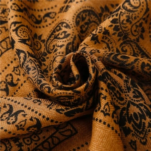Detailed macro view of the paisley and leopard pattern on the cotton-linen shawl fabric