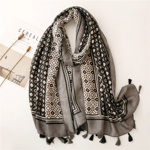 Linen feel scarf with geometric patterns and fringe tassels in grey and cream tones