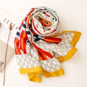 Detail of cotton linen scarf with colorful chain letters and interlocking patterns