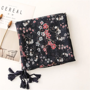 Close-up of navy floral scarf with red blossoms and delicate fringe tassel details