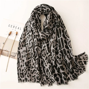 Linen feel scarf with leopard print and gold foil accents for sun protection and style