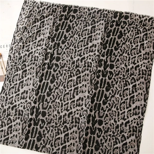 Detail of leopard print scarf with delicate frayed edges and linen-like texture