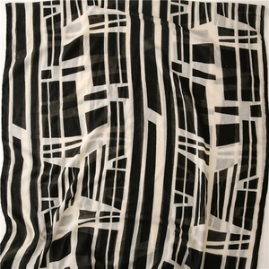 Detail of lightweight black and white geometric scarf showing soft fabric texture