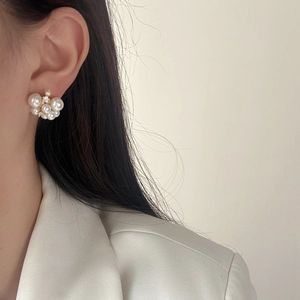 Elegant clusters of lustrous pearls and sparkling zircons studs shown on a model