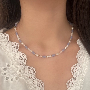 Elegant purple agate and freshwater pearl necklace on model with white lace clothing