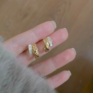 Geometric C-shape quilted gold earrings with white shell inlay for a luxury minimalist look