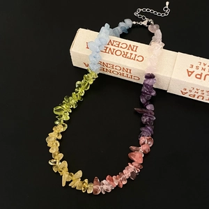 Detailed shot of multi-color natural gemstone chips necklace with metal lobster clasp