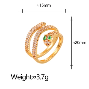 Vintage gold snake ring with white zircon pave and green gem eyes in spiral design