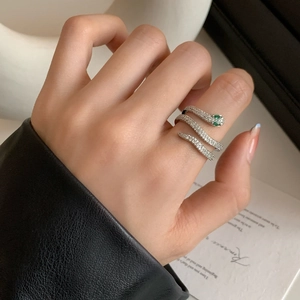 Elegant silver snake wrap ring with white zircon stones and emerald green gem eyes