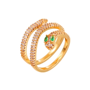 Vintage gold snake ring featuring shimmering white crystals and green emerald-like eyes
