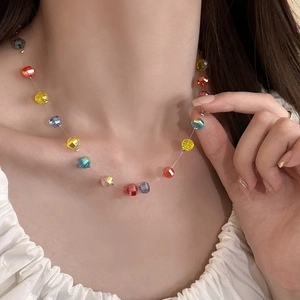 Close-up of colorful faceted pumpkin beads necklace on collarbone for a vibrant summer look