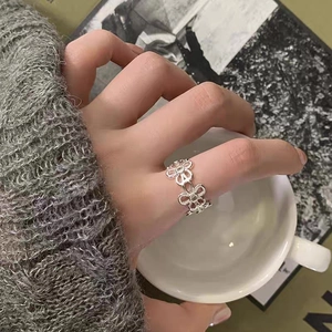 Primo piano di un anello a margherita traforato in argento con pietre di zircone