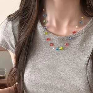 Detail of colorful faceted crystal beads on a model, showcasing texture and vibrant colors