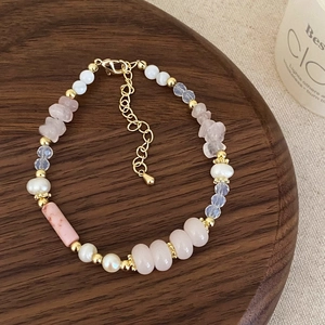 Detail of pink crystal and freshwater pearl beaded necklace with gold lobster clasp