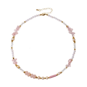 Pink crystal and freshwater pearl beaded necklace with gold lobster clasp on white background