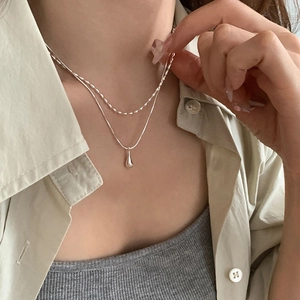 French minimalist double-layer necklace with teardrop pendant in polished silver finish
