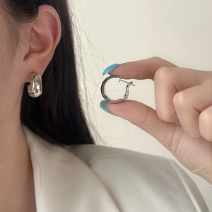 Minimalist silver geometric C-shape hoop earrings with a polished mirror finish for women