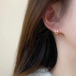 Exquisite hollow pig-nose earrings with micro-inlaid zircons shown on model ear