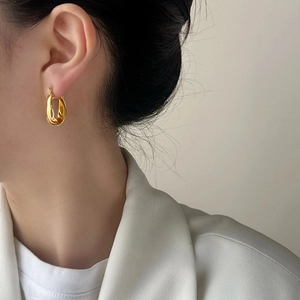 French style gold twisted hoop earrings for women with a minimalist metallic finish