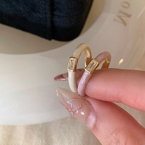 Elegant cream and lavender enamel rings with rectangular cubic zirconia on gold bands