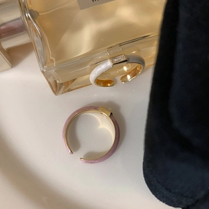 Detail of adjustable gold rings with enamel inlay and rectangular zircon stones