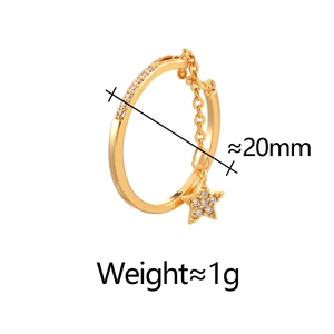 Detail view of gold hoop earring with star charm and cubic zirconia measuring 20mm
