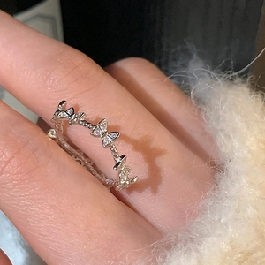 Elegant butterfly micro-set zircon silver ring showing shadow effect on hand