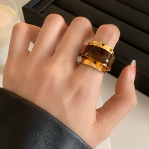 French vintage irregular gold metal ring with dark brown enamel on model's finger