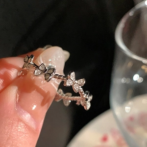 Macro shot of micro-set zircon butterfly ring with twisted rope band and silver finish