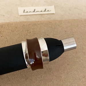 Macro detail of French retro irregular silver ring with dark brown enamel finish