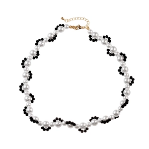 Elegant beaded necklace with white pearls and black beads in a floral petal design