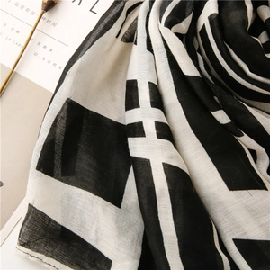 Detail of classic black and white grid scarf with breathable texture and neat edges
