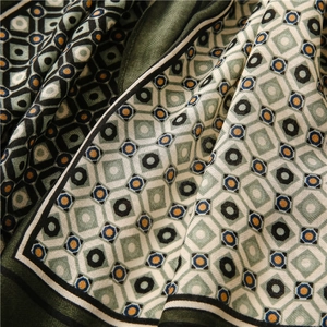 Detail of soft cotton-linen feel scarf with geometric diamond print and herringbone texture