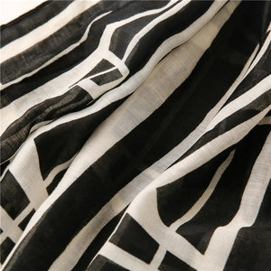 Macro shot of black and white geometric pattern on soft cotton linen scarf fabric
