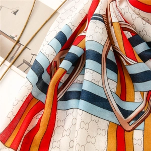 Macro shot of cotton linen scarf showing soft texture and colorful chain print