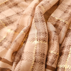 Detail of herringbone linen texture scarf with gold foil accents and houndstooth pattern