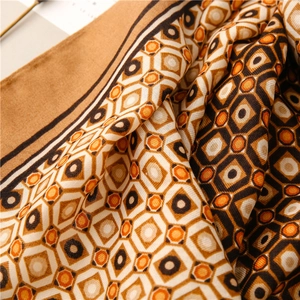 Detailed close-up of geometric diamond pattern and herringbone weave on linen-feel scarf