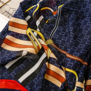 Macro shot of cotton linen scarf texture featuring luxury chain and letter patterns