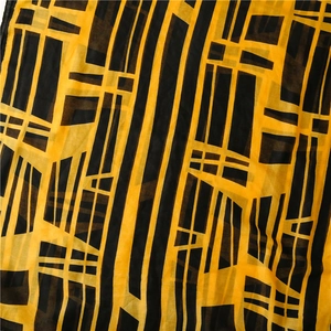 Detail of yellow and black geometric woven scarf with modern abstract line patterns